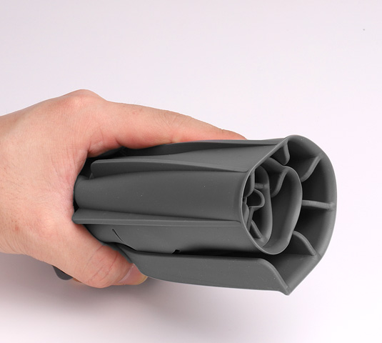 Flexible silicone faucet drip catcher tray rolled up by hand